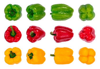 Green, red and yellow sweet bell peppers arranged in rows with water drops, isolated on white background. Organic fresh vegetables, macro photography