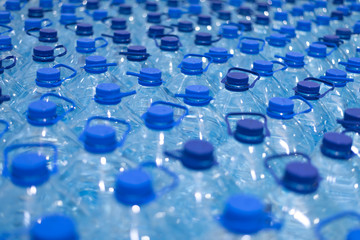 Lot of bottles worth with clean cool natural water. Group of plastic bottles with water stand in a row.