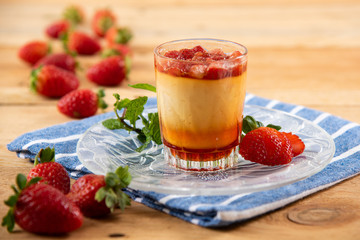Apricot panacota surrounded by strawberries