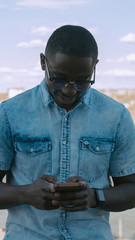 young man texting and smiling