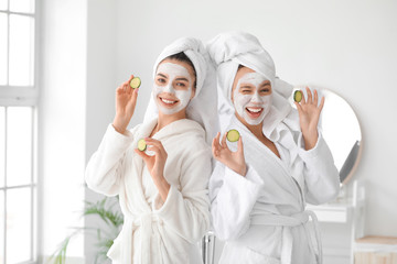 Beautiful young women taking care of their skin in bathroom
