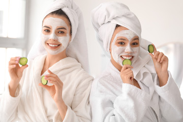 Beautiful young women taking care of their skin in bathroom