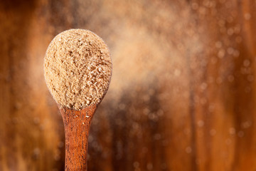 Maca powder in wooden spoon - Lepidium meyenii.