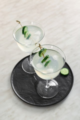 Glasses of tasty cucumber martini on table