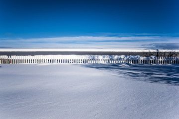 Winter landscape with fence