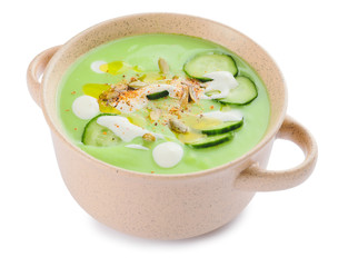 Pot with cold cucumber soup on white background