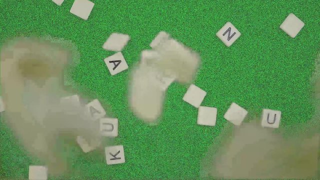 Random Alphabet Scrabbles falling down to green background . alphabet dropping on green table