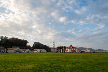 Fototapeta na wymiar View to the Golden Gate Bridge from Crissy Field Park. White houses with red roof