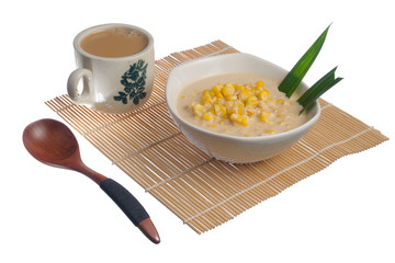 Corn porridge  in white bowl and a cup of coffee  isolated on white background