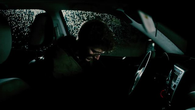 A man puts his seat-belt on and looks at his keys, wondering if he should drive. He decides to. 

Tripod. Narrative. Medium-Close Field of View. 23.975 FPS.