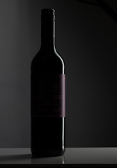 Dark wine bottle on dark background