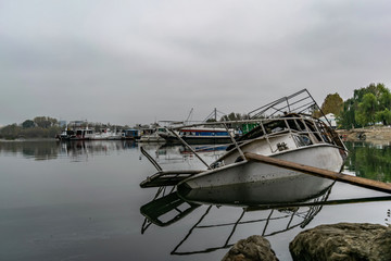 Abandoned fishing boat half-sunk near coast