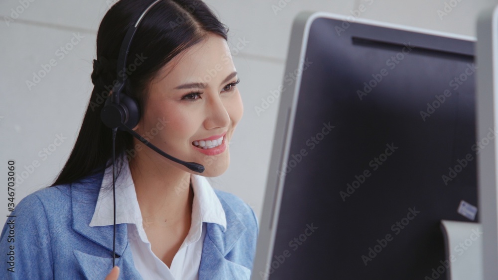 Aufkleber customer support agent or call center with headset works on desktop computer while supporting the cu