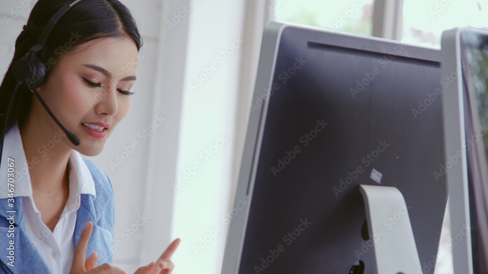 Poster customer support agent or call center with headset works on desktop computer while supporting the cu