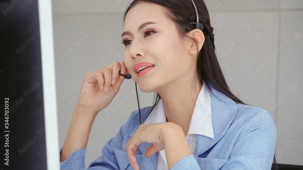 Aufkleber customer support agent or call center with headset works on desktop computer while supporting the cu