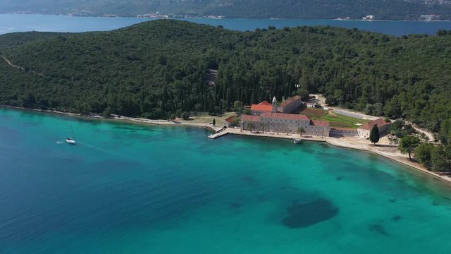 Beautiful Franciscan Monastery Badija on Island of Badija, southern Croatia, surrounded with turquoise Sea - Aerial Panoramic View