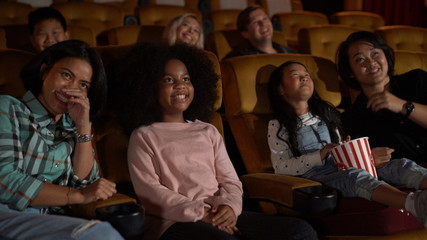 People audience watching movie in the movie theater cinema. Group recreation activity and...