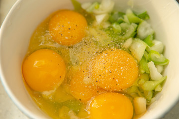 Eggs, spring onion and seasoning in bowl