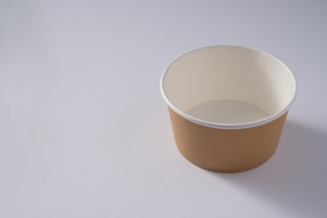 Big brown paper plate isolated on white background. Eco-friendly disposable food packaging. Preserving nature and recycling concept. Copy space