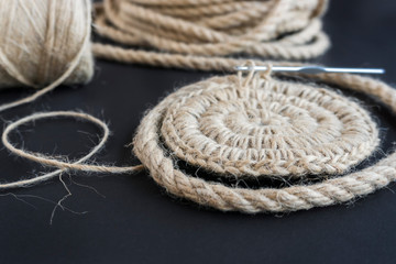 layout on a black background, knitting a jute basket from a rope. Hobbies to do at home in quarantine