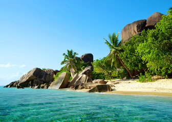 Beatiful beach Anse Source d'Argent with big granite rocks in sunny day. La Digue Island, Seychelles.
