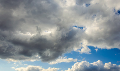 Rain clouds in the blue sky.