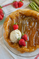 Rhubarb upside down cake with strawberries and ice cream