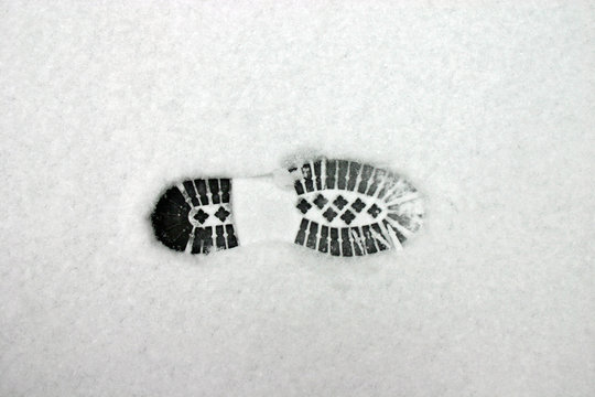 Directly Above Shot Of Shoeprint On Snow