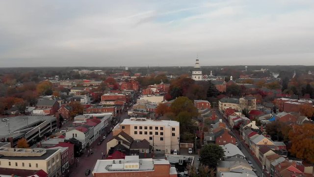 A drone flies over Annapolis capturing images of the historic town as it approaches the Maryland Statehouse Capitol Building on an autumn morning.