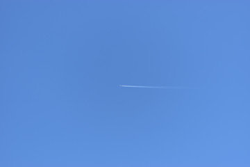 Image of Airplane leaving contrails in the clear sky