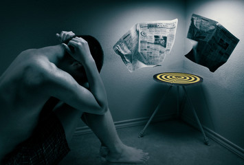 young man in room with flying newspaper