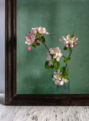 Still life with a flowering branch in the frame. Interior.