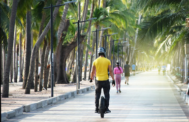 riding on mono wheel or electric unicycle for exercise in morning time after the government approval to relaxation measures people use to public park between epidemic covid-19.  © Taweesak