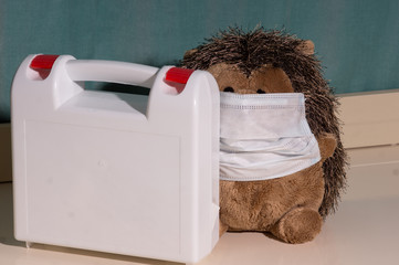 Hedgehog plush toy in a medical mask