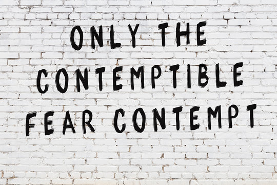 Black painted inscription of smart quote on white brick wall