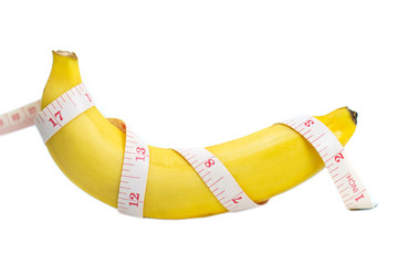 A banana was wrapped in a measuring tape. isolated