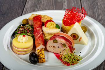 food platter with meat rolls and meatballs with cheese and meat and vegetables with sauces