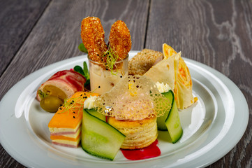 food platter with meat rolls and meatballs with cheese and meat and vegetables with sauces