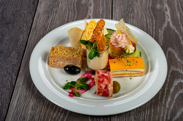 food platter with meat rolls and meatballs with cheese and meat and vegetables with sauces