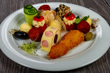 food platter with meat rolls and meatballs with cheese and meat and vegetables with sauces