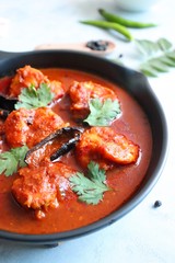 Goa Food-Indian Traditional Goan Prawns or Shrimp curry. Kolambiche kalwan/Tikhle. Hot and spicy homemade fish gravy cooked using coconut milk & Indian spices. ingredients background with copy space.