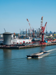 Rotterdam, Netherlands - May 07, 2020: view on the cargo port buildings infrastructure from cruise...