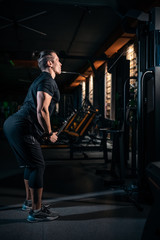 young athlete has physical workout with barbell in modern gym