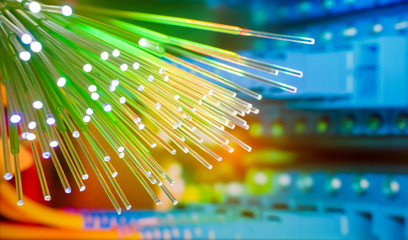 Fiber optics network cable on technology background