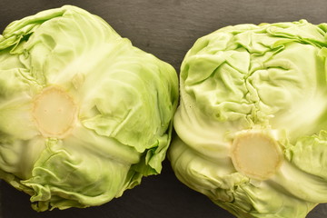 Fresh green cabbage on a slate board, closeup.