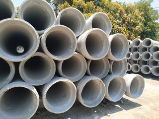 Pile of cement pipes close-up.