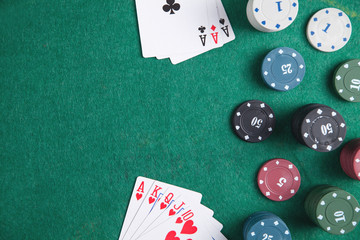 Casino chips and cards on the green table.