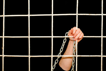 Quarantine pandemic restriction concept a hand with chain behind iron bars