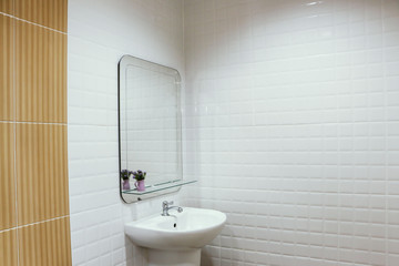 Wash basins and mirrors in white bathrooms