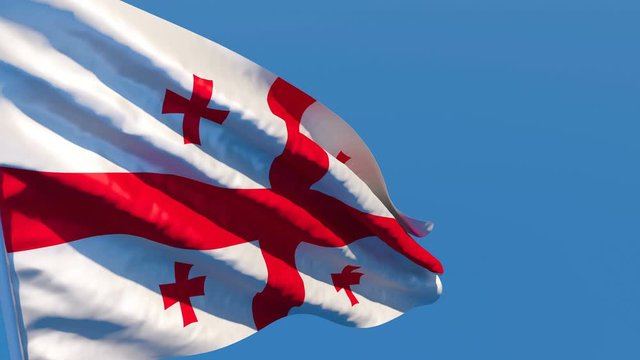 The national flag of Georgia is flying in the wind